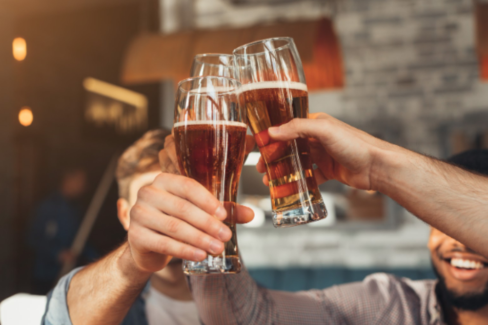 A group of friends toasting to National Beer Day